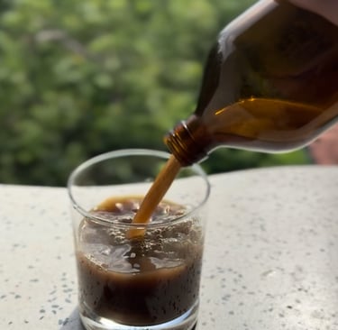 Ayurvedic medicine tonic being poured in a glass