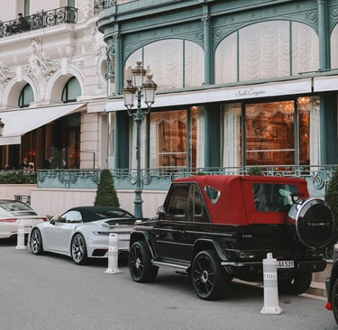 Luxury Cars Parked Outside Elegant Hotel Facade during Monaco Grand Prix