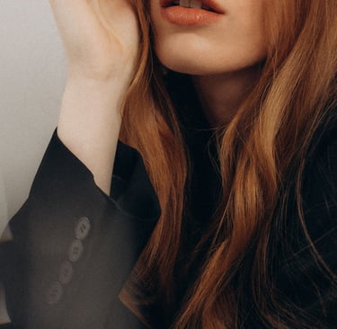 a woman with long hair and a black jacket