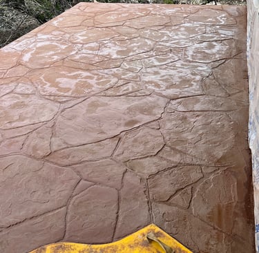 Colored and stamped concrete balcony after waterproofing deck.