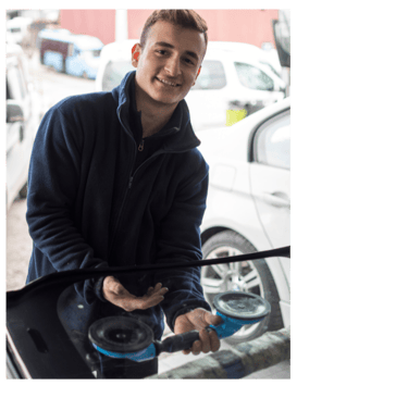 a man is holding a car with a car washer