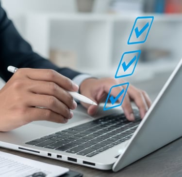 Close-up of professional using laptop with checklist overlay, symbolizing ERP business case success.