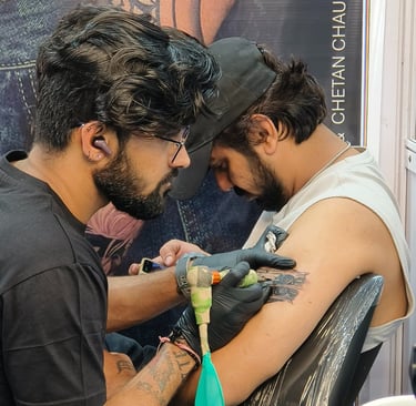 a man getting a tattoo on his arm