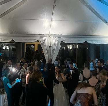 a group of people standing around a tent