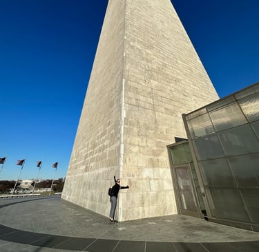 A normal sized person holding the Washington monument. There are substantial size difference between