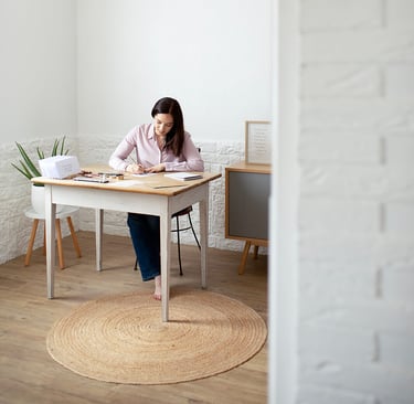 a woman sitting at a table with papers