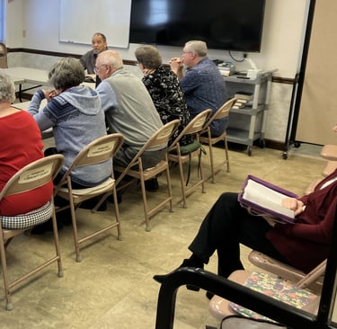 people sitting at a table studying the Bible 