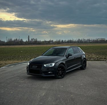 A black car parked in a parking lot