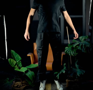 a man in a black shirt and white sneakers