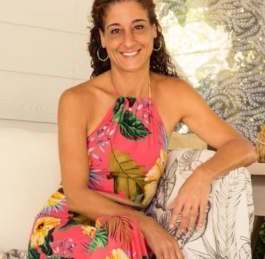 a woman in a floral dress sitting on a bench