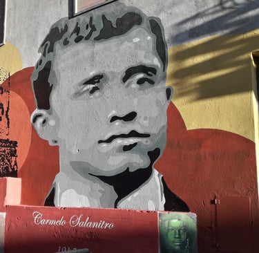 Mural dedicated to Carmelo Salanitro, created by Poliops on an urban wall, a historical commemorativ