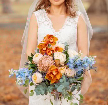 a bride in a white wedding dress holding a bouquet