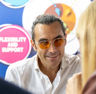 Matteo Borea smiling with customers during a coffee exhibition