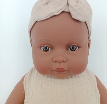 Close up of Minikane toddler doll with brown eyes