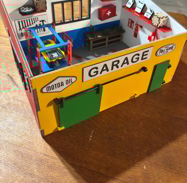 a toy garage with a garage and tools, diorama