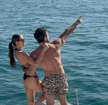 a man and woman standing on a boat