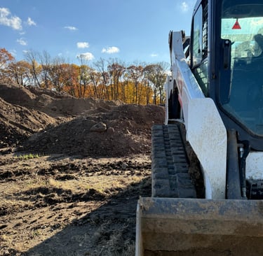 skid-steer-with-dirt-pile