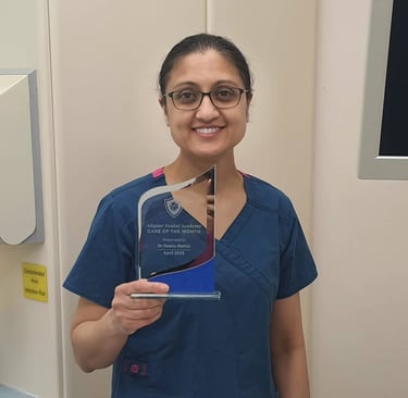 a woman in scrubs and scrubs holding a plaque
