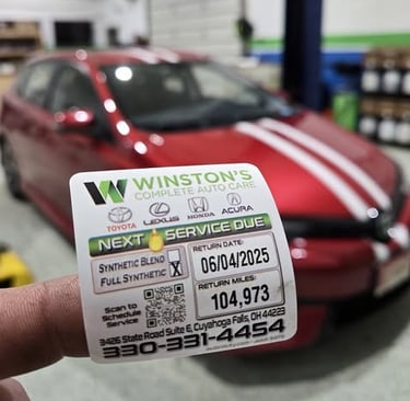 Car Service Sticker being placed on a car at Winston's Complete Auto Care in Cuyahoga Falls, Ohio