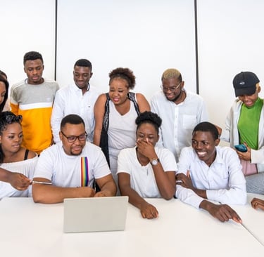 a group of people standing around a table