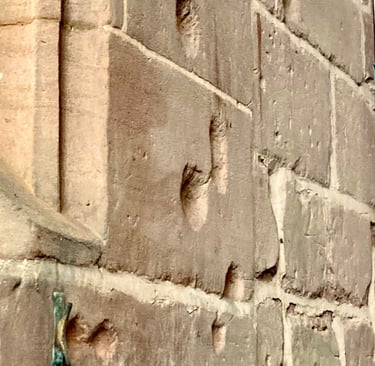 photograph showing musket damage to a stone wall.