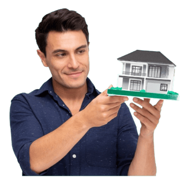 a man holding a model of a house