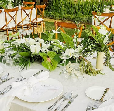 a table with a table setting with white tablecloth and white tablecloth