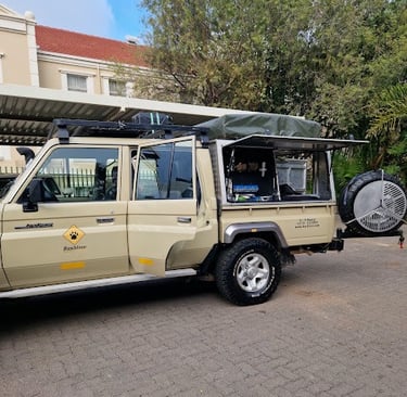 a vehicle parked in a parking lot with a tenter and a tent