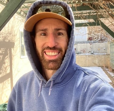 a man in a blue hoodie and a hat