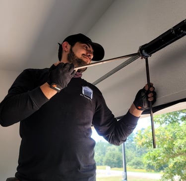 Alex Hernandez a garage door technician installing a new spring for a garage door