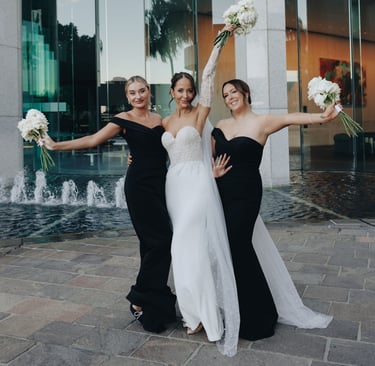 a bride and bridesmaid posing for a photo