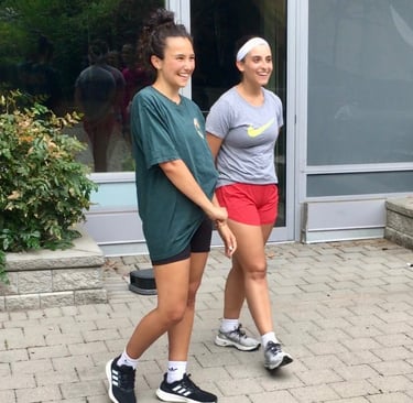 Two women after Jeet Kune Do North York training in a courtyard area.