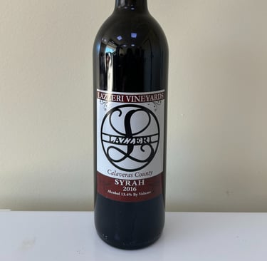 An unopened bottle of wine labeled Syrah