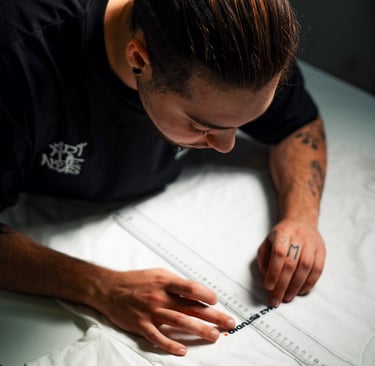 a man is looking down at a white sheet of paper