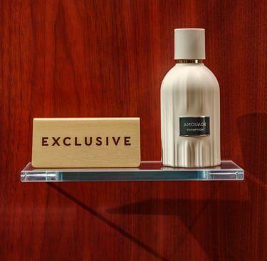 Exclusive Amouage reception perfume bottle on wood backdrop.