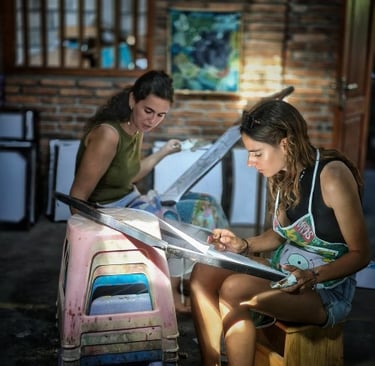 a woman doing batik in a batik studio