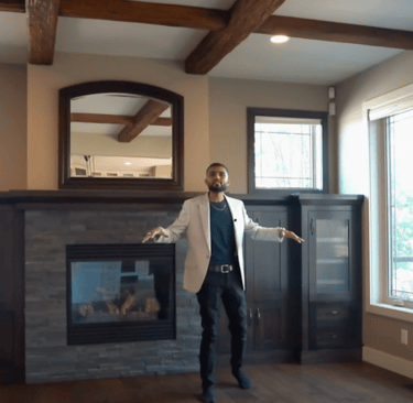 a man standing in a room with a fireplace