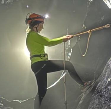 Tracey Billington climbing through the James Bond hole in Hang Son Doong Cave to get to doline 1