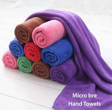 a pile of Micro Bre hand towels on a white floor