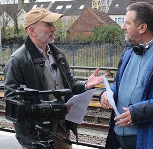 Chris Kirk and Stephen Cranford discussing a shot