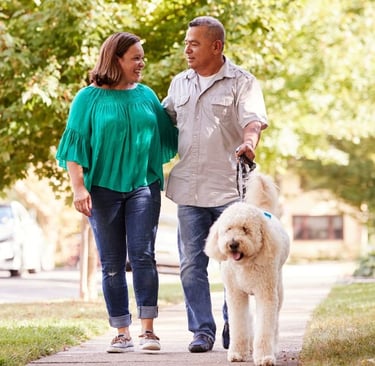 couple walking dog