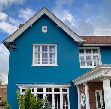 Frontal view on blue villa with red lion rampant in a painted white shield.