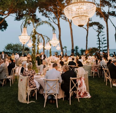 Elegant outdoor dinner at Villa El Rincon with chandeliers and guests under the trees