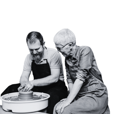 A man and woman using a pottery wheel