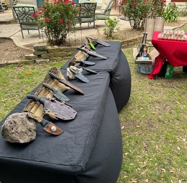 a table with a bunch of knives and knives on it