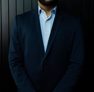 a man in a suit and a watch on a black background