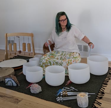 A woman playing on the sound bowls
