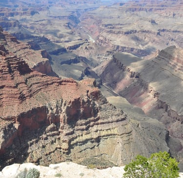 a man standing on a cliff overlooking a canyon