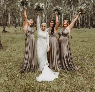 a bride and her bridesmaid posing for a photo
