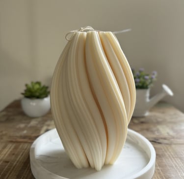 White twisted candle over a plate